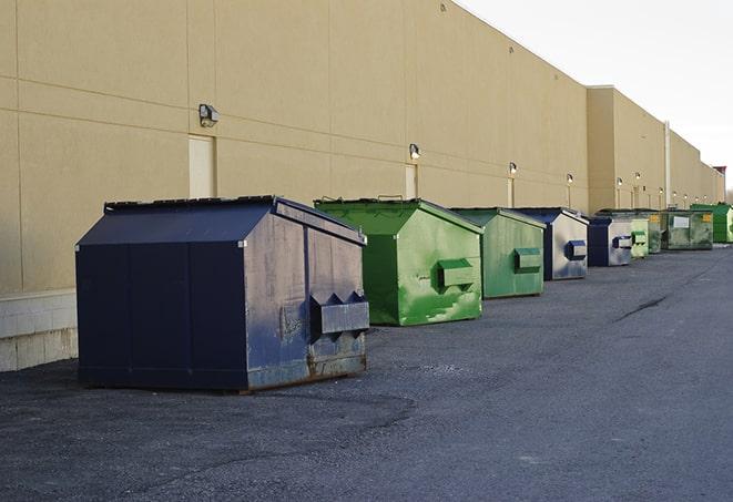 construction crew disposing of building materials in large bins in Ellsworth KS